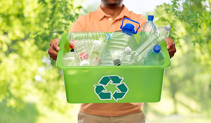 Image showing close up of young man sorting plastic waste