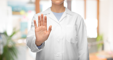 Image showing female doctor in white coat showing stop gesture