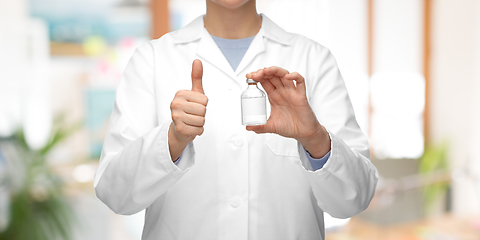 Image showing close up of doctor with medicine showing thumbs up