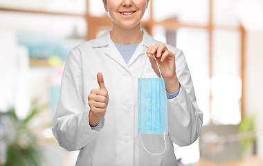 Image showing female doctor with medical mask showing thumbs up