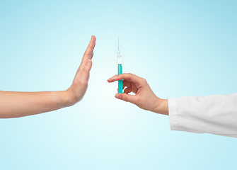 Image showing hand with syringe and showing stop gesture