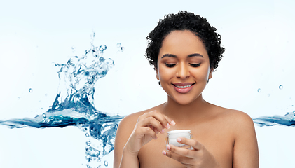 Image showing young african american woman with moisturizer