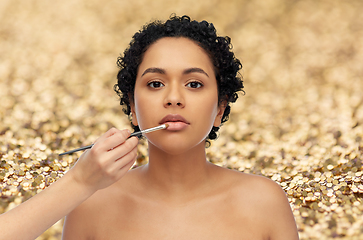 Image showing woman and hand of make up artist with brush