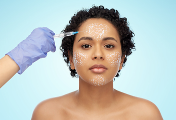 Image showing face of african woman and hand with syringe