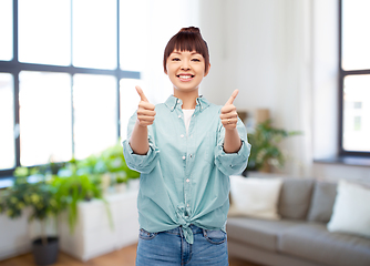 Image showing happy asian woman showing thumbs up over white