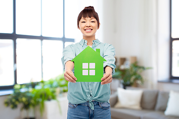 Image showing smiling asian woman holding green house