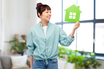 Image showing smiling asian woman holding green house