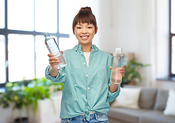 Image showing asian woman with plastic and glass bottle of water