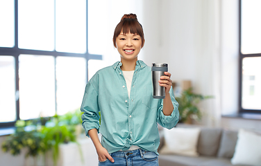 Image showing woman with thermo cup or tumbler for hot drinks