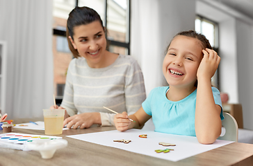 Image showing happy mother with little daughter drawing at home