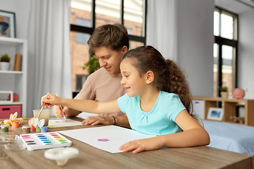 Image showing happy father with little daughter drawing at home