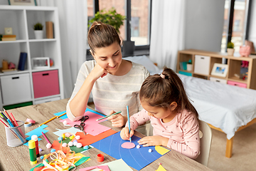 Image showing daughter with mother making applique at home