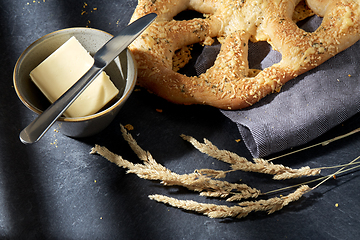 Image showing close up of cheese bread, butter and table knife