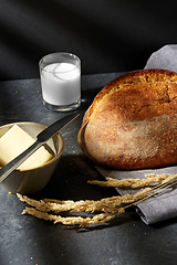 Image showing close up of bread, butter, knife and glass of milk