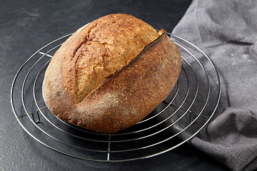 Image showing homemade craft bread on stand on table