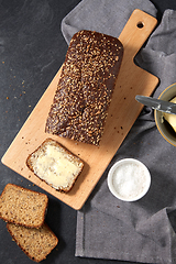 Image showing close up of bread, butter, knife and salt on towel