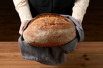 Image showing female baker with homemade bread at bakery