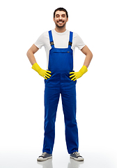 Image showing happy male worker or cleaner in overal and gloves