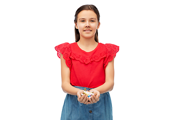 Image showing smiling girl holding pile of alkaline batteries