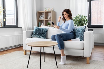 Image showing woman with smartphone having video call at home