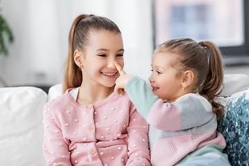 Image showing two happy smiling little girls or sisters at home