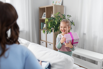 Image showing happy daughter giving present to mother at home