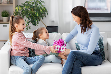 Image showing daughters giving present to happy mother