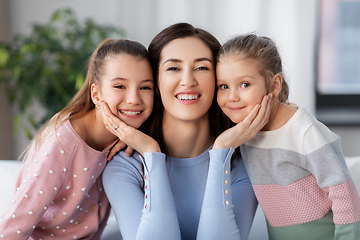 Image showing happy smiling mother with two daughters at home