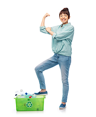 Image showing smiling young asian woman sorting plastic waste