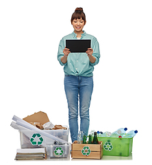 Image showing smiling asian woman with tablet pc sorting waste