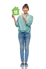 Image showing smiling asian woman holding green house