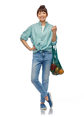 Image showing happy asian woman with food in reusable string bag