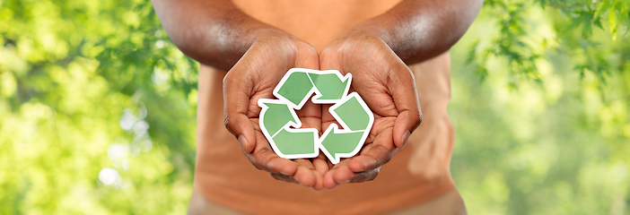 Image showing close up of man holding green recycling sign