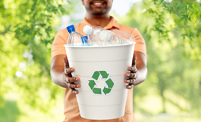 Image showing close up of young indian man sorting plastic waste