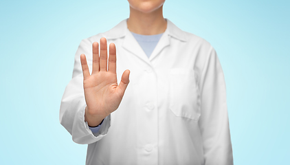 Image showing female doctor in white coat showing stop gesture