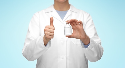 Image showing close up of doctor with medicine showing thumbs up