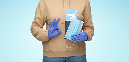 Image showing woman with mask, passport and ticket shows ok sign