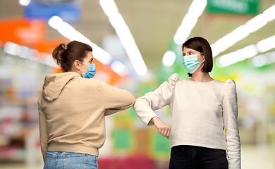 Image showing women in masks making elbow bump greeting gesture