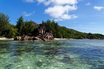 Image showing Beach on Curieuse Island, Seychelles, with lava stone rocks and lush vegetation