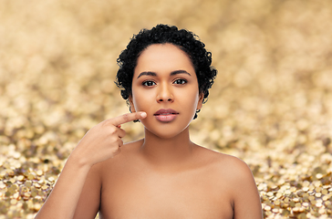 Image showing young african american woman pointing to her lips