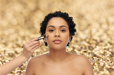 Image showing woman and hand of make up artist with brush