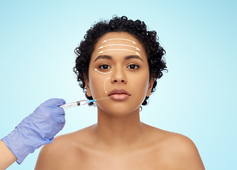 Image showing face of african woman and hand with syringe