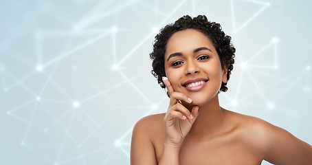 Image showing young african american woman with moisturizer