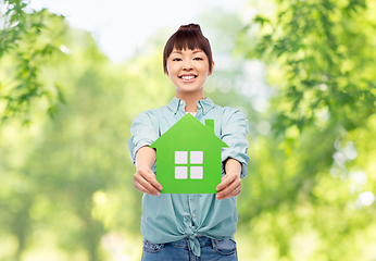 Image showing smiling asian woman holding green house