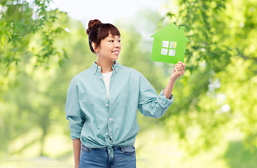 Image showing smiling asian woman holding green house