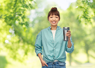 Image showing woman with thermo cup or tumbler for hot drinks