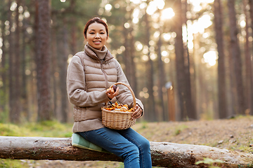 Image showing woman with mushrooms in basket in autumn forest