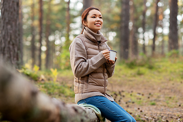 Image showing asian woman with mug drinking tea in forest