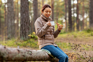 Image showing woman drinking tea and eating sandwich in forest