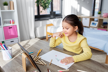 Image showing little girl drawing with coloring pencils at home